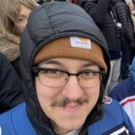 A photo of a smiling white man wearing glasses